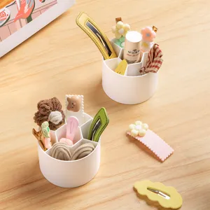Compact white round multi-grid desktop organizer for hair clips, stationery, and makeup items.
