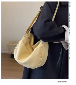 Vue détaillée du sac porté épaule en toile unie décontractée avec design souple et sangle.