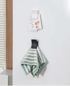 Wall-mounted multi-functional storage clip detail showing memo card and towel hanging.
