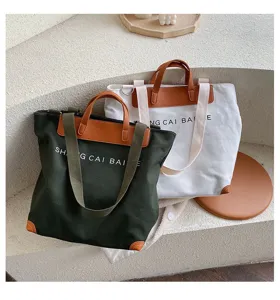 Canvas shoulder crossbody tote bag for women, large capacity casual handbag with letters.