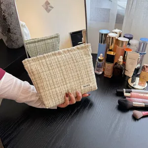 Tweed cosmetic bag for women, large capacity makeup pouch, stylish vanity storage and wash bag.