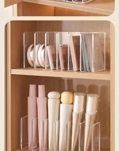 Clear acrylic eyeshadow palette and vertical skincare organizer stand for cabinet storage.