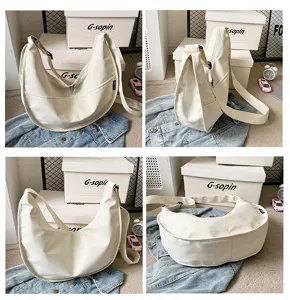 Detailed view of the white nylon minimalist crescent crossbody bag showcasing its spacious shape.