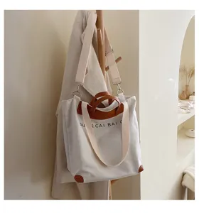 Canvas tote bag for women, stylish shoulder crossbody bag with leather handles and wide strap.
