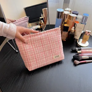 Pink tweed cosmetic bag with large capacity, elegant style storage pouch for daily makeup essentials.