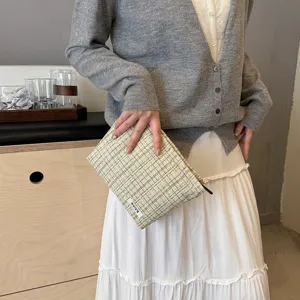 Tweed cosmetic pouch detail view, stylish large capacity makeup organizer bag for women.