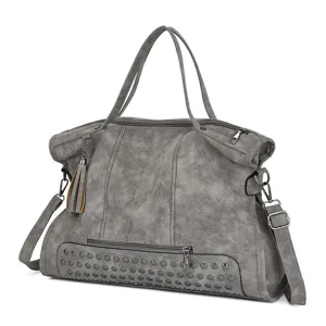 Close-up of the grey PU leather shoulder bag featuring rivet details and tassel accent.