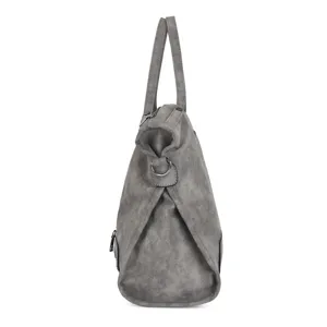 Side profile detail of grey faux leather tote shoulder bag with zip and metal ring accents.