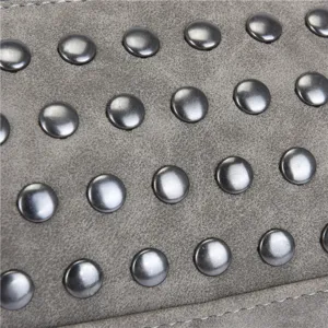 Grey faux suede women bag detail featuring metallic rivet studs and precise stitching design.