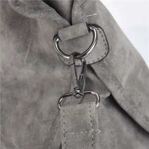Close-up detail of retro frosted PU leather shoulder bag with metallic clasps and strap.