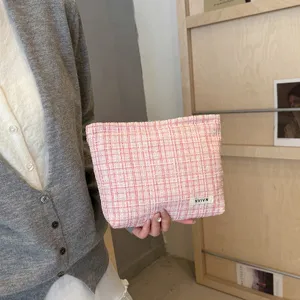 Pink tweed cosmetic bag with zipper, large capacity stylish storage pouch for daily use.