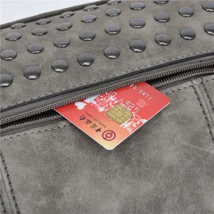 Grey suede PU leather handbag detail showing metal studs and zipper pocket with card insert.