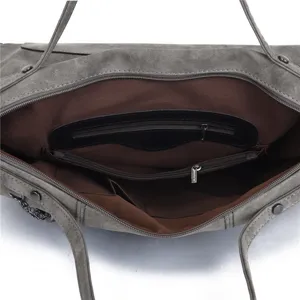Interior detail of vintage frosted PU leather shoulder handbag showing zipper pocket.