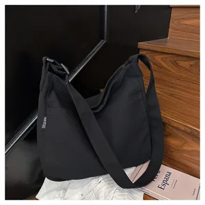 Black canvas crossbody bag detail, large capacity casual shoulder bag for women daily use.