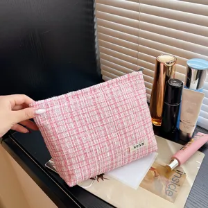 Pink tweed makeup bag detail showcasing soft texture, elegant cosmetic storage pouch for women.