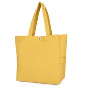 Large capacity yellow canvas tote bag for women, stylish casual shoulder handbag for daily use.