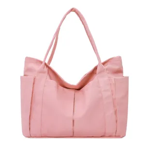 Pink canvas tote bag with large capacity, multiple pockets and durable shoulder straps.