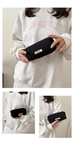 Canvas pencil case detail view showing black pouch with white label and clean stitching.