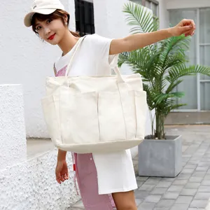 Large capacity canvas tote bag, casual shoulder handbag with multiple exterior pockets.