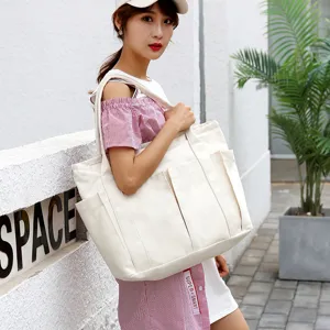 Large capacity canvas tote bag for women, multi-pocket casual shoulder bag, daily use.