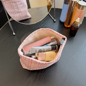 Pink tweed cosmetic bag with large capacity for travel, stylish makeup storage pouch for daily use.