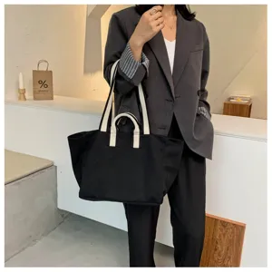 Black canvas tote bag for women, large capacity shoulder bag, casual commuting handbag.