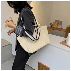 Detailed view of women casual canvas tote bag with contrast shoulder straps for commuting.