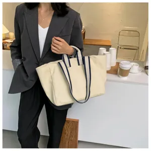 Minimalist canvas tote bag for women, large capacity shoulder bag for daily office commuting.