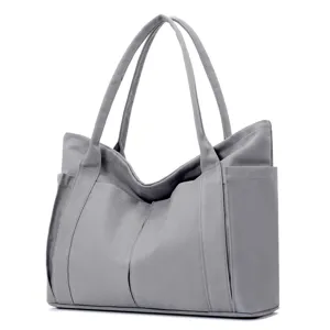 Detailed view of the large capacity gray canvas tote bag with multiple pockets and shoulder straps.