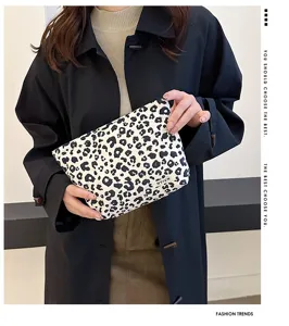 Leopard print cosmetic makeup pouch detail view, showing soft fabric texture and storage capacity.