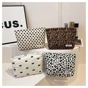 Portable canvas cosmetic bag, cute leopard and dot print storage pouch for daily travel use.