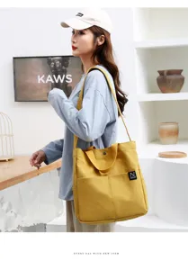 Yellow canvas tote bag for women, casual single shoulder bag with dual handles and pockets.