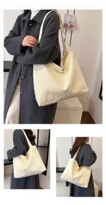 Detail view of the casual beige canvas tote bag worn on shoulder, showing large capacity.