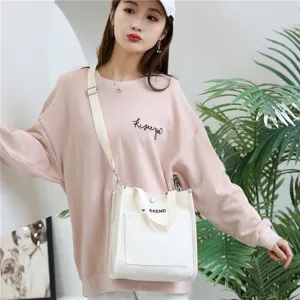 Japanese style white canvas shoulder bag for women casual daily commute versatile tote handbag.