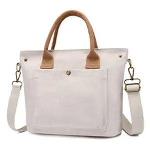 Casual canvas tote bag with brown handles and shoulder strap, stylish daily shoulder handbag.
