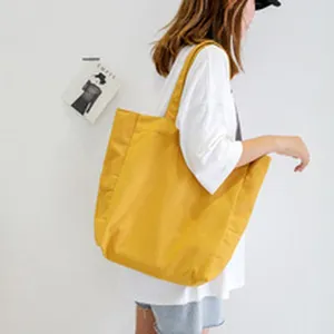 Simple yellow canvas tote bag for women, large capacity casual shoulder bag for daily use.