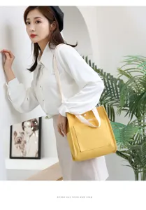 Japanese style yellow canvas shoulder bag detail view with front pocket and white straps.
