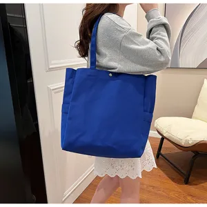 Solid color canvas tote bag for women, large capacity shoulder bag for daily work and commuting.