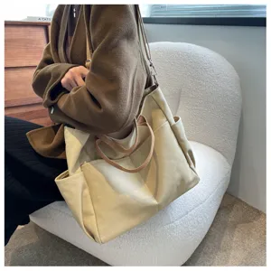 Beige multi-pocket canvas tote bag detailed view, showing durable fabric and functional shoulder straps.