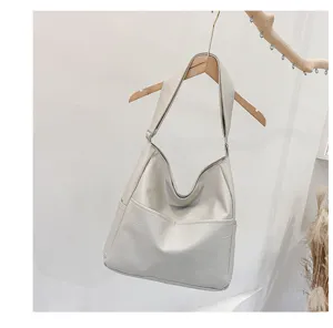 Soft PU leather slouchy shoulder bag detail showcasing fine stitching and clean texture.