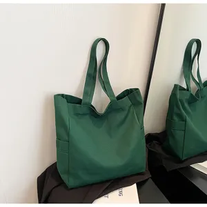 Dark green canvas tote bag, large capacity shoulder bag, casual everyday commuting bag.