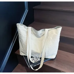 Detail shot of large capacity casual tote bag with multi-pocket and double shoulder straps.