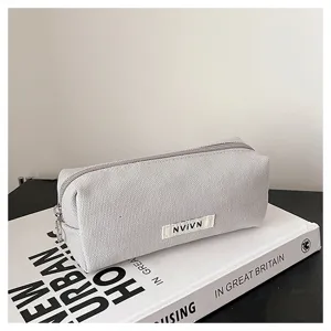 Grey canvas pencil case detail view, minimalist stationery pouch with zipper closure.