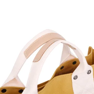 Canvas tote bag handle detail showing durable stitching, sturdy hardware, and grip.