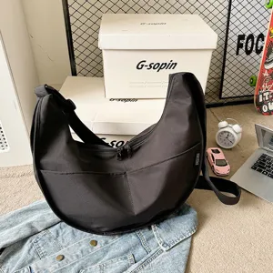 Detailed view of a casual black nylon crescent shoulder bag, perfect for daily streetwear style.