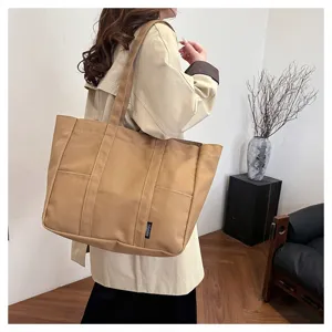 Close-up detail of large canvas tote shoulder bag, ideal for daily commute and casual style.