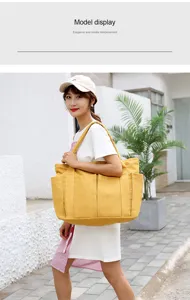 Spacious canvas tote bag for women, casual shoulder handbag with multiple utility pockets.