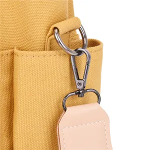 Canvas handbag metal hardware detail shot showing durable clasp and sturdy strap attachment.