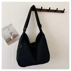 Black canvas hobo shoulder bag detail, casual daily crossbody bag with adjustable strap.