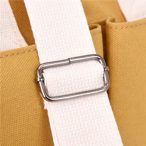 Canvas tote bag shoulder strap adjustment metal buckle hardware fine detail shot